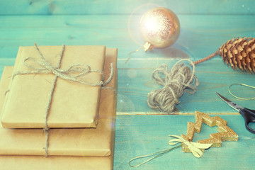  Preparation for the new year. Gifts, scissors, ribbon and bumps on a wooden background