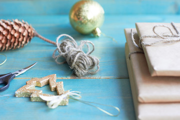  Preparation for the new year. Gifts, scissors, ribbon and bumps on a wooden background
