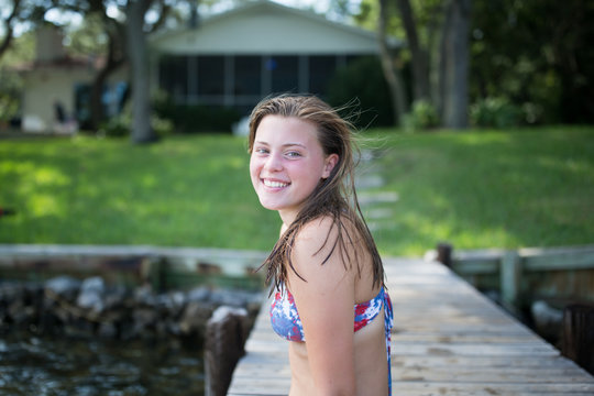 Portrait of teenage girl on jetty, smiling