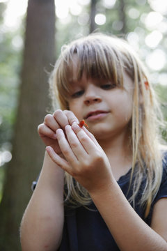 Young girl holding newt