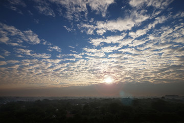 Wide angle of sunrise at countryside in Myanmar on a cloudy and foggy day from high point of view