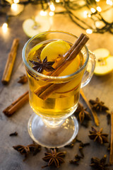  Mulled cider in glass on wooden table. Christmas drink