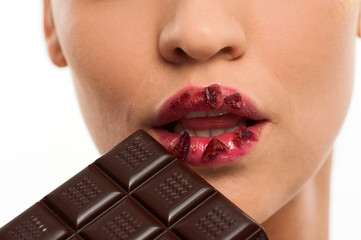 Model taking a bite of chocolate with red lips
