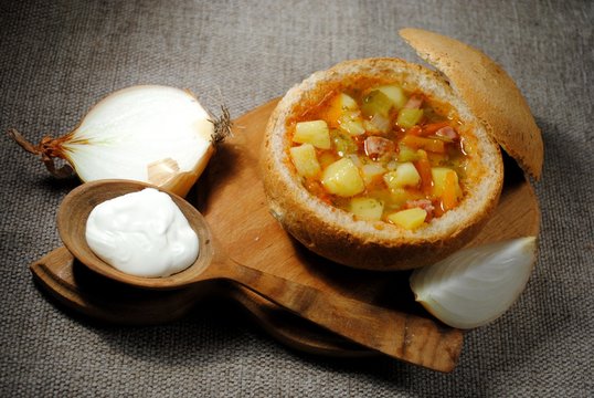serving a dish in a bowl of bread. soup in a bowl of bread