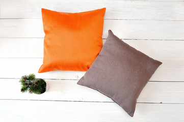two pillows on a white wooden background. Flat lay, top view photo mockup