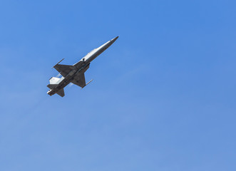 Fototapeta na wymiar fighter jet military aircraft flying on blue sky background
