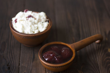 curd and jam in a clay pot on a wooden table