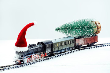 Snow-covered Christmas train with a Christmas tree. Closeup. - 181021074