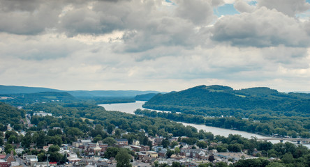 Riverside Town Under Cloudy Skies