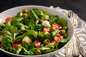 Salad with tomatoes, mozarella and olives.