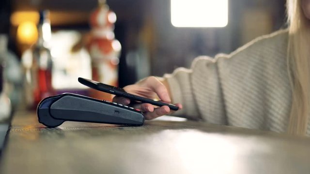 Customer uses smartphone to make a wireless payment.