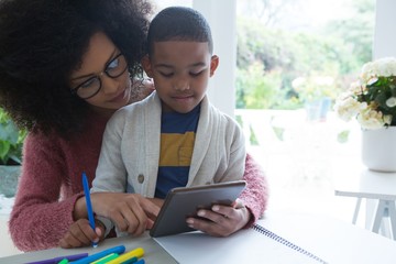 Mother and son using digital tablet