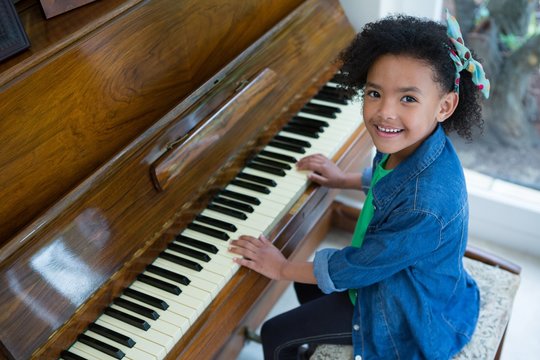 Adorable girl playing piano - Powered by Adobe
