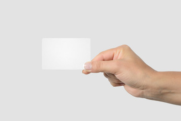 Obraz premium Mockup of female hand holding a Business Card isolated on light grey background. 