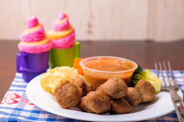 Meatballs with cucumber, carrot, brocolli, black pepper sauce and  mashed potato in white plate. Healthy eating concept.
