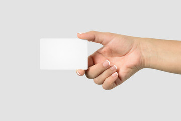 Mockup of female hand holding a Business Card isolated on light grey background. 