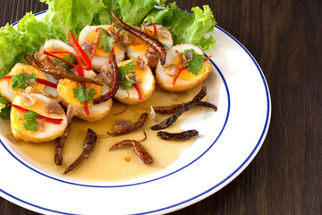 Sweet and sour eggs in white dish Thai food