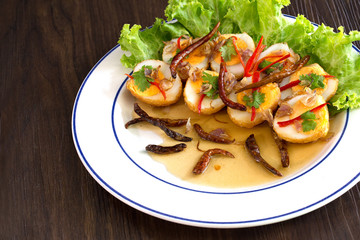 Sweet and sour eggs in white dish Thai food