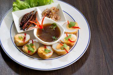 Sweet and sour eggs in white dish  Thai food