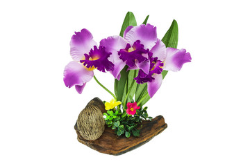 Plastic orchid on wood
