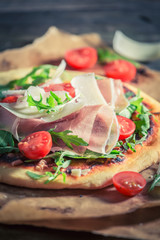 Delicious pizza with tomatoes, basil and cheese