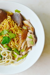 Chinese egg noodle with duck meat and bean sprout on bowl