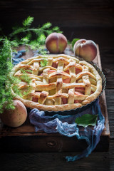 Homemade and delicious peaches pie on blue cloth
