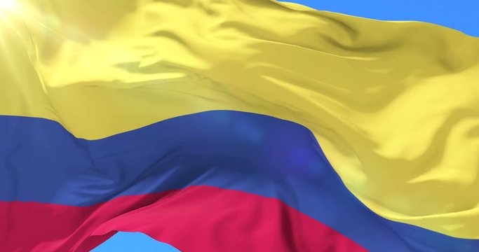 Colombian flag waving at wind in slow with blue sky, loop