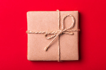 Gift box on red background. Flat lay. Color surge.