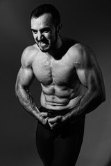 Fototapeta premium Muscular screaming man with a naked torso.