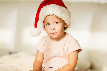 Little girl in santa hat. Portrait of beautiful baby girl