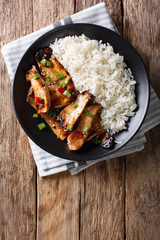 spicy king oyster mushrooms with chili and onions and rice garnish close-up. Vertical top view