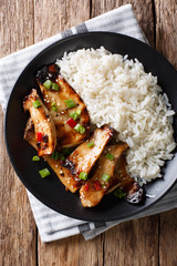 Fried spicy King Brown Mushroom with rice close-up on a plate. Vertical top view