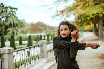 Girl doing sports in a park in the fall.