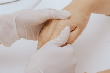 Application of cream on female hands
