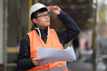 Young Asian engineer working on construction site