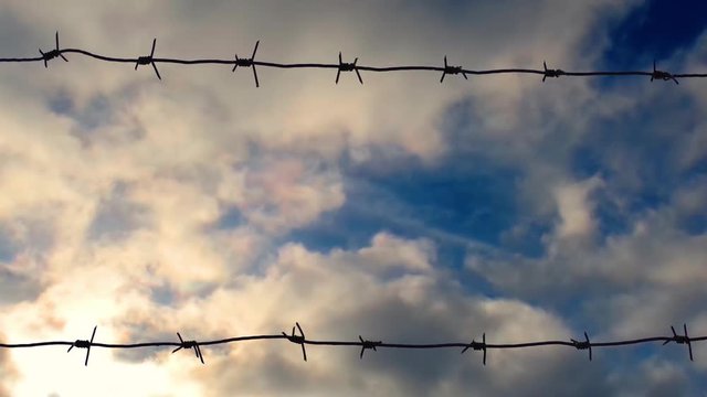old barbed wire against the sky, time lapse