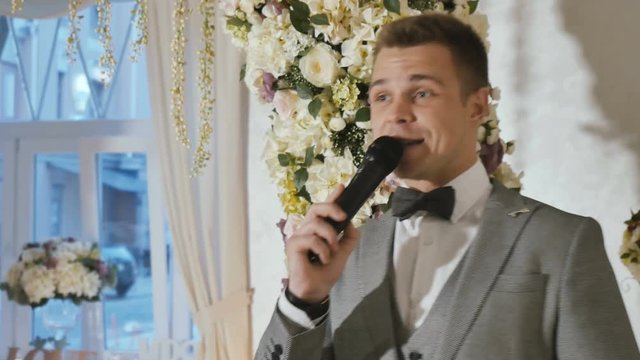 Handsome party host leads wedding ceremony