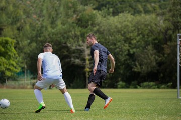 Obraz premium Football players playing soccer in the ground