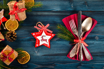 Christmas serving cutlery with plate on a wooden background.