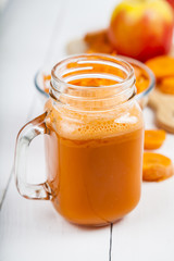 Apple-carrot juice on a wooden table.