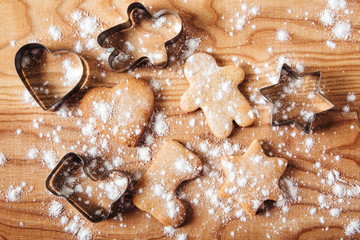 Gingerbread and cookie cutters background.Cooking and holiday concept.Wooden table.Top view.Flat lay.