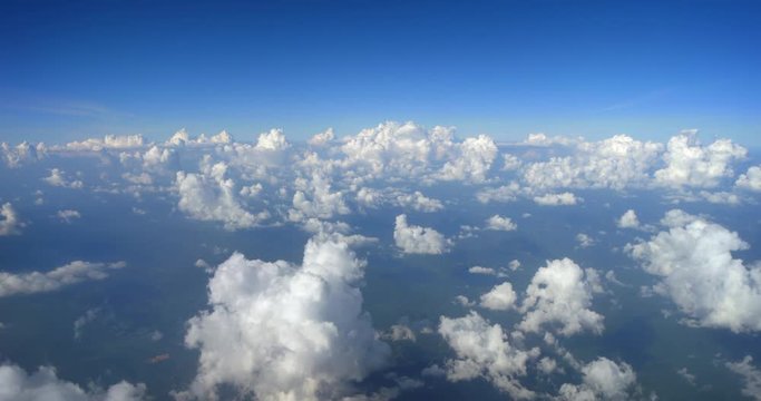 Puffy Popcorn Clouds from Airplane Window. 4k DCI footage