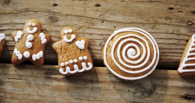 Various cookies and candy cane arranged on wooden table 