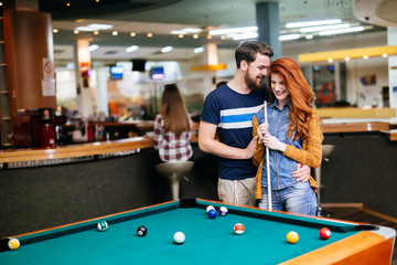 Couple spending time together by playing pool