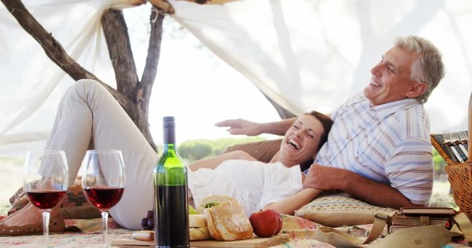 Happy couple relaxing under shed 
