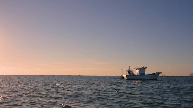 footage at the sunset of the stagnone park near trapani and marsala in sicily in backlight with moored boats