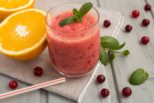Smoothie from cranberry and orange on the grey napkin