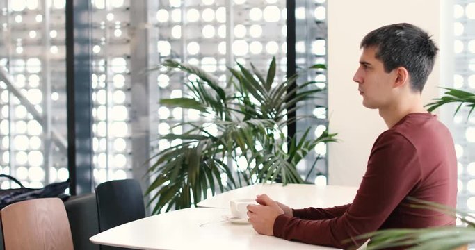 Young couple at cafe. Woman giving slap to man. Guy sticks to the girl unsuccessfully. Girl get away