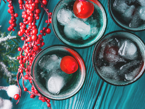 Short alcohol green drinks with cherry and crushed ice. Christmas Saint Patrick day holiday shot